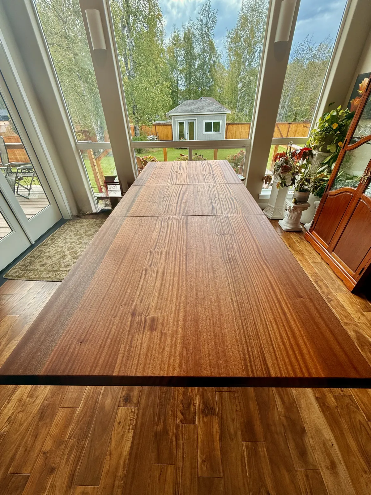 Overhead view of sapele dining table showing full-length grain pattern