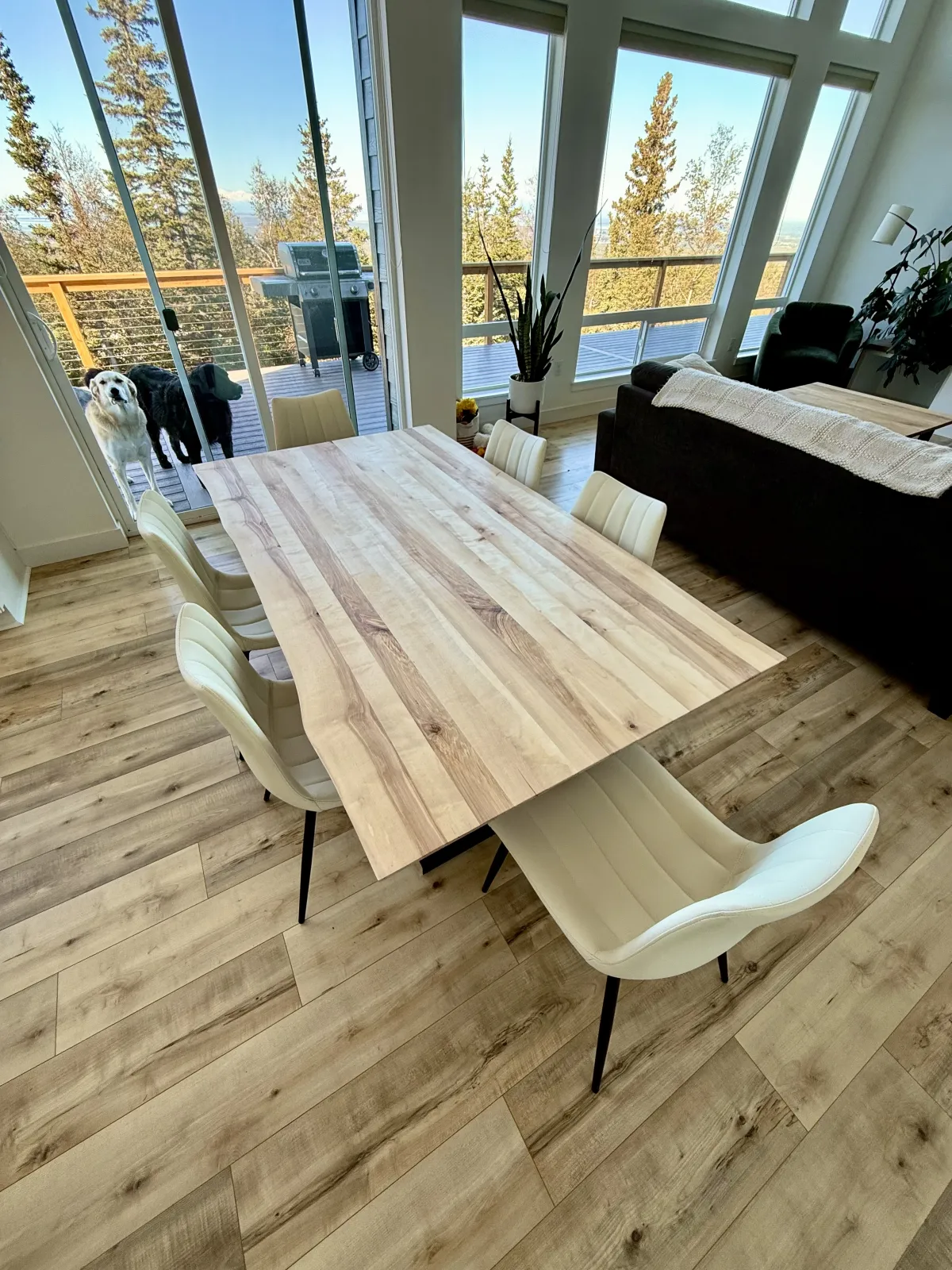 Light birch dining table in modern Alaska home with mountain views